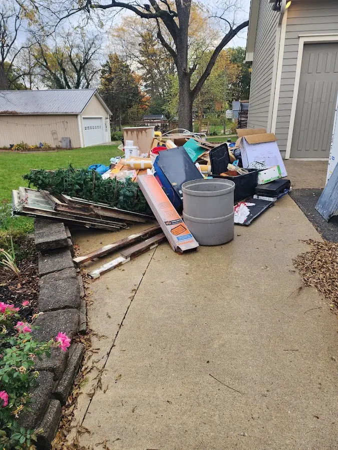 Dumpster being loaded with debris for Estate Cleanout Dumpster Rental in Mechanicsville